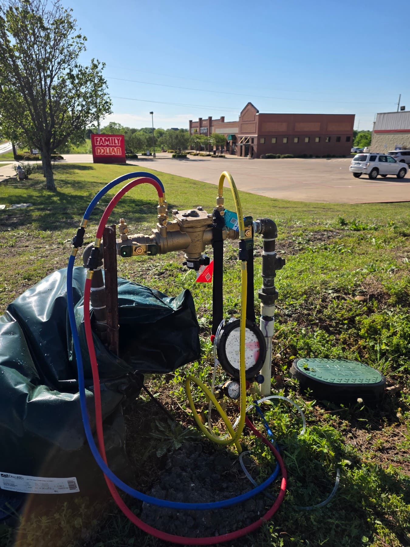 Larry's Plumbing testing a commercial backflow assembly at a Rockwall-area shopping center