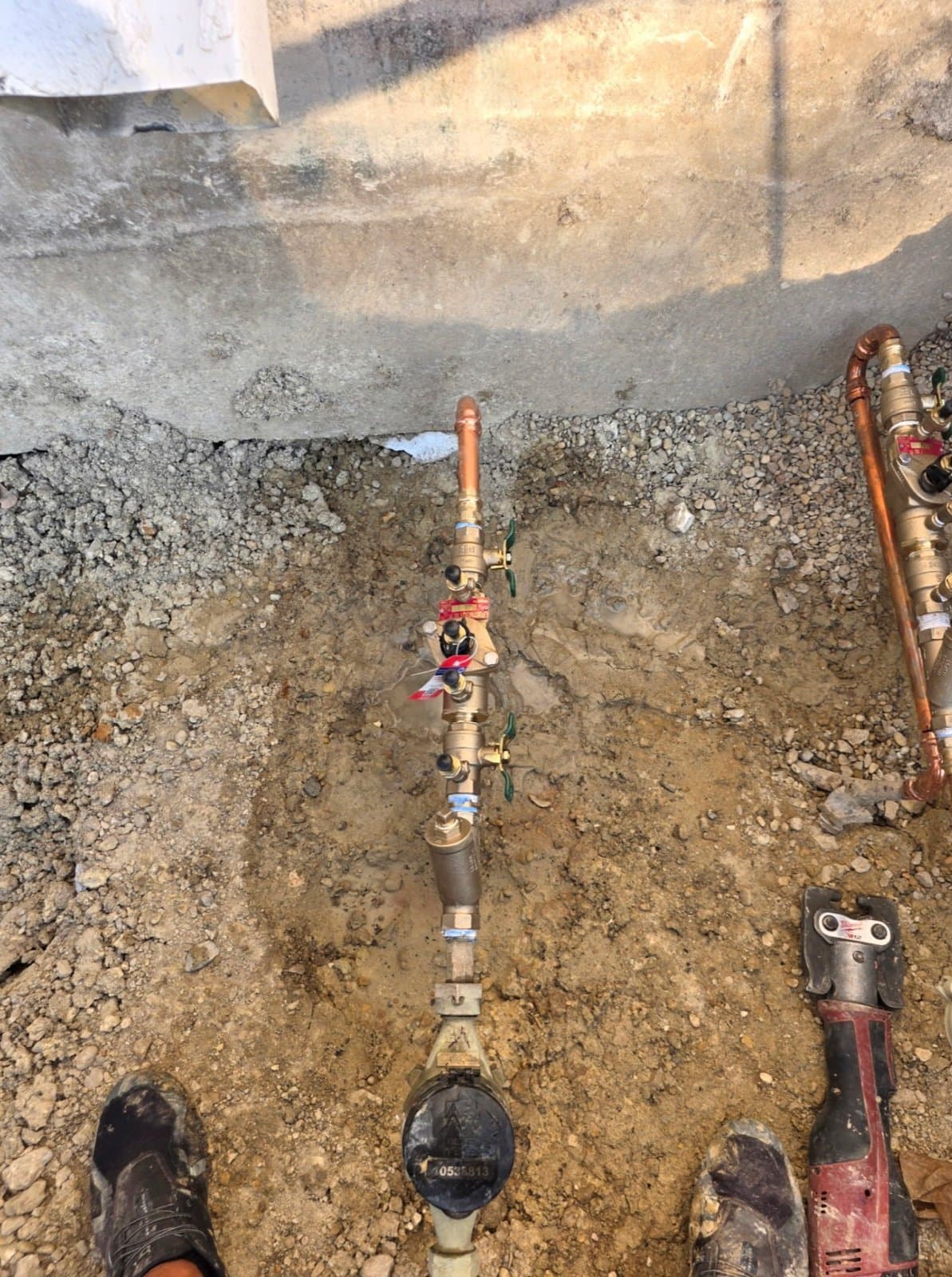 Larry's Plumbing servicing multiple double check backflow assemblies on a commercial job